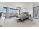 Bright bedroom with large windows, a modern chandelier, and a stylish gray and black color scheme at 1247 Shaw View Alley # 101, Raleigh, NC 27601