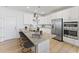 Well-equipped kitchen with white cabinetry, stainless steel appliances, and island seating at 1247 Shaw View Alley # 101, Raleigh, NC 27601
