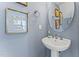 Chic powder room with pedestal sink, elegant mirror, and soothing blue walls at 1247 Shaw View Alley # 101, Raleigh, NC 27601