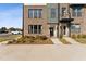 Inviting brick townhome featuring well-manicured landscaping and sidewalk leading to the front door at 1259 Shaw View Alley # 101, Raleigh, NC 27601