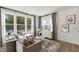 Cozy living room with large windows and a comfortable sectional sofa and stylish decor at 1259 Shaw View Alley # 101, Raleigh, NC 27601
