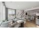 Open-concept living space with modern decor, hardwood floors, and seamless flow to the kitchen at 1259 Shaw View Alley # 101, Raleigh, NC 27601