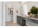Elegant bathroom with gray cabinets, large mirror, and stylish decor for a spa-like experience at 1259 Shaw View Alley # 201, Raleigh, NC 27601