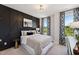 Stylish bedroom showcasing a black accent wall, neutral bedding, and patterned curtains at 1259 Shaw View Alley # 201, Raleigh, NC 27601