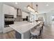 Modern kitchen features an island with white countertop, stainless steel appliances, and stylish pendant lighting at 1259 Shaw View Alley # 201, Raleigh, NC 27601
