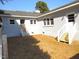 Light grey house in backyard featuring two sets of stairs, small grass area and blue skies at 136 Dogwood Trl, Wendell, NC 27591