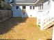 View of the backyard with stairs up to the house and surrounded by wood fence at 136 Dogwood Trl, Wendell, NC 27591