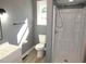 This bathroom features a bright white shower, toilet, vanity, and light gray walls at 136 Dogwood Trl, Wendell, NC 27591