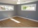 A bright bedroom with hardwood floors, neutral gray walls, and bright windows at 136 Dogwood Trl, Wendell, NC 27591