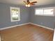 Bright bedroom with hardwood floors and natural light from two windows, ready for customization at 136 Dogwood Trl, Wendell, NC 27591