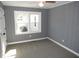 Comfortable bedroom with soft carpeting, window, closet door and light gray walls at 136 Dogwood Trl, Wendell, NC 27591