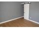 Bedroom featuring hardwood floors and a modern sliding closet door at 136 Dogwood Trl, Wendell, NC 27591
