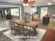 Bright open-concept dining area with modern table and chairs, seamlessly flowing into the kitchen at 136 Dogwood Trl, Wendell, NC 27591
