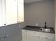 Functional laundry room featuring upper and lower cabinets with a sink and countertop at 136 Dogwood Trl, Wendell, NC 27591