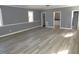 Large living room with multiple windows, wood-look floors, and neutral walls at 136 Dogwood Trl, Wendell, NC 27591