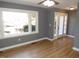 Bright living room featuring hardwood floors, a large window and entry door with side windows at 136 Dogwood Trl, Wendell, NC 27591