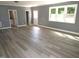 Empty living room ready for your personal touch, featuring large windows and wood flooring at 136 Dogwood Trl, Wendell, NC 27591