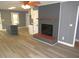 Cozy living room showcasing a fireplace, gray brick, and wood-look floors at 136 Dogwood Trl, Wendell, NC 27591