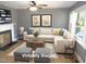 Bright living room featuring hardwood floors, a cozy fireplace, and large windows for natural light at 136 Dogwood Trl, Wendell, NC 27591