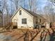 Exterior view of home featuring deck, yard with mature trees, and siding at 180 Carolina Ridge Rd, Pittsboro, NC 27312