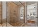 Walk-in shower featuring pebble floor and tile walls, glass door, with access to the main bedroom at 1881 Edith Dr, Raleigh, NC 27612