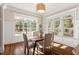 Bright dining area with large windows, hardwood floors, and stylish lighting at 1881 Edith Dr, Raleigh, NC 27612