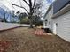 Large backyard features deck, gray siding, and white fence, ready for landscaping at 208 Lawrence Rd, Cary, NC 27511