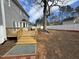 Expansive backyard featuring a wooden deck, tall mature trees, and a new white fence at 208 Lawrence Rd, Cary, NC 27511