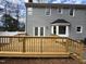 Freshly built backyard deck with railings, stairs, and gray siding at 208 Lawrence Rd, Cary, NC 27511