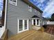 Spacious backyard deck with gray siding, perfect for outdoor entertaining at 208 Lawrence Rd, Cary, NC 27511