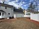 Back exterior of the home with air conditioning units and a new white fence at 208 Lawrence Rd, Cary, NC 27511