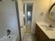 Bathroom leading to laundry area showing single sink vanity and shower-tub combo at 208 Lawrence Rd, Cary, NC 27511