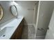 Bathroom featuring double sinks with white countertops and a tiled shower, and a modern design at 208 Lawrence Rd, Cary, NC 27511