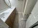 Bathroom with double vanity, wooden cabinets, white counters, and modern gray flooring at 208 Lawrence Rd, Cary, NC 27511