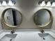 Bathroom features double sink with two stylish round mirrors and modern vanity lighting at 208 Lawrence Rd, Cary, NC 27511