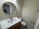 Bathroom featuring a single sink vanity with round mirror at 208 Lawrence Rd, Cary, NC 27511