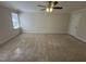 Spacious bedroom with a ceiling fan, large window, and neutral-toned carpet at 208 Lawrence Rd, Cary, NC 27511
