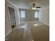 Bedroom with a ceiling fan, two windows, and beige carpet protected by plastic film at 208 Lawrence Rd, Cary, NC 27511