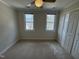 This bedroom has great natural light, with a ceiling fan for added comfort, and neutral walls at 208 Lawrence Rd, Cary, NC 27511