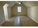 Spacious bedroom features neutral carpet, ceiling fan and natural light from the window at 208 Lawrence Rd, Cary, NC 27511