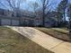 Charming two-story home featuring a classic facade, attached garage, and long driveway at 208 Lawrence Rd, Cary, NC 27511