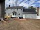 Rear exterior of the home with a spacious backyard, wooden deck, and fenced yard at 208 Lawrence Rd, Cary, NC 27511