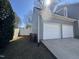 Home's two-car garage exterior, showcasing the home's siding and well-kept yard at 208 Lawrence Rd, Cary, NC 27511