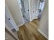 Hallway view leading to a bathroom with neutral walls and modern gray flooring at 208 Lawrence Rd, Cary, NC 27511