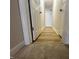 Hallway showing carpet and wood floors with doors at 208 Lawrence Rd, Cary, NC 27511