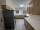 Bright kitchen with stainless steel appliances, quartz countertops, and natural light at 208 Lawrence Rd, Cary, NC 27511