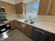 Well-lit kitchen with stainless appliances, quartz counters, window over sink, and light wood cabinets at 208 Lawrence Rd, Cary, NC 27511