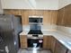Updated kitchen with wooden cabinets, countertops, and stainless steel appliances at 208 Lawrence Rd, Cary, NC 27511