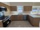 Renovated kitchen featuring new cabinets, countertops, and stainless steel appliances at 208 Lawrence Rd, Cary, NC 27511
