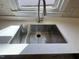 Stainless steel kitchen sink with modern faucet and white quartz countertop at 208 Lawrence Rd, Cary, NC 27511